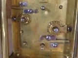 a gold clock that is sitting on a table