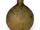 a green glass vase with a pinecone design on it