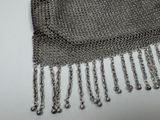 a close up of a chainmail purse on a white surface