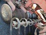 an image of a close up of a tractor with a plow attached to it