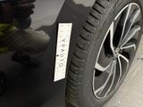 a close up of a car ' s tire with a sticker on it