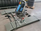 a close up of a machine on a platform in a warehouse