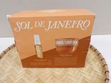 a box of perfume sitting on top of a wicker basket