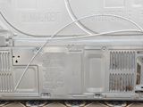 a white television sitting on top of a tiled floor
