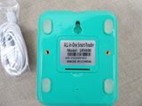 a green box with a white cord attached to it