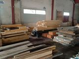 many pieces of wood that are stacked up in a warehouse