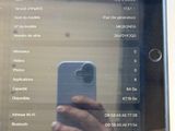 a person taking a picture of a cell phone on a table