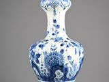 blue and white vase with a floral design on the bottom