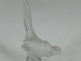 a glass bird that is sitting on top of a table