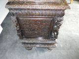 a wooden chest with carvings on it in a room