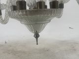a glass chandelier hanging from the ceiling in a room