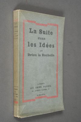 an old book with a red border on it sitting on top of a table