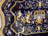 a blue and gold plate with a design on it