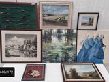 a table that has a bunch of paintings on it