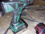 a drill that is sitting on the floor in the garage
