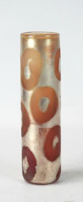 a glass vase with an orange and white design on it