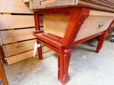 a red table with a drawer on it in a room
