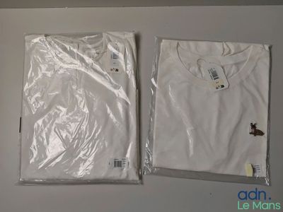 two white t - shirts on a white table