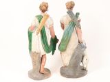 pair of figurines of a man and a woman with a dog