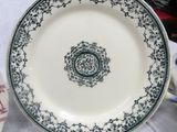 a white plate with a blue and green design on it