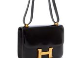 un sac à main noir orné d'un « H » doré sur la poignée