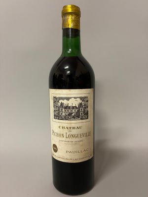 a bottle of red wine sitting on top of a table