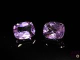pair of purple amethorate gems on black background