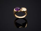 a gold and amethorate ring with a purple stone
