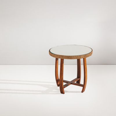 une petite table ronde avec un plateau en verre et des pieds en bois