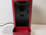 a red coffee maker that is sitting on a table