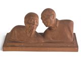 statue of a man and a woman sitting on a book