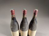 three bottles of wine sitting on top of a table next to each other