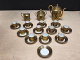 many cups and saucers sitting on a table