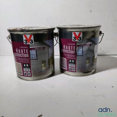 two cans of paint sitting on a table