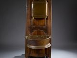 a tall wooden cabinet with a mirror on top of it