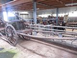 a horse drawn carriage inside of a building with a lot of wood