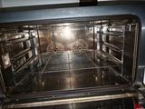 an open oven that has a lot of food inside of it