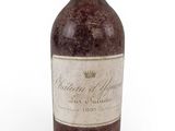 a bottle of wine sitting on top of a white surface