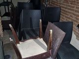 several chairs and a table in a room with a brick wall
