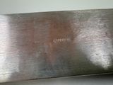 a silver plate with a name on it on a table