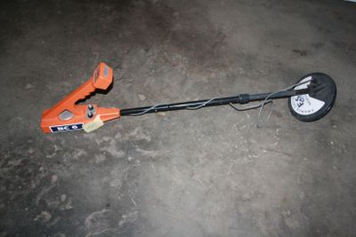 an image of a lawn mower laying on the ground