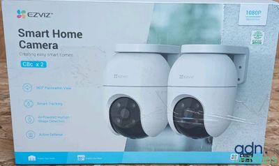 a box with two cameras sitting on top of it