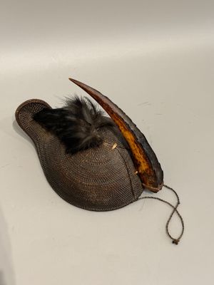 a hat with a feather on it sitting on a sink