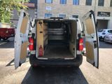 a white van with its doors open in a parking lot