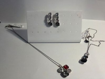a necklace and earring set sitting on a table