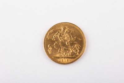 a gold coin on a white surface with a white background