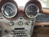 two gauges on the dashboard of an old car