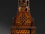 a wooden clock tower with a star of david on the top of it