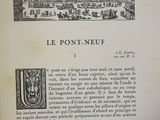 an open book with a drawing of a city and a picture of a castle
