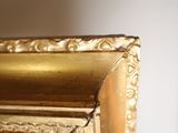 a close up of a gold frame with a clock on it